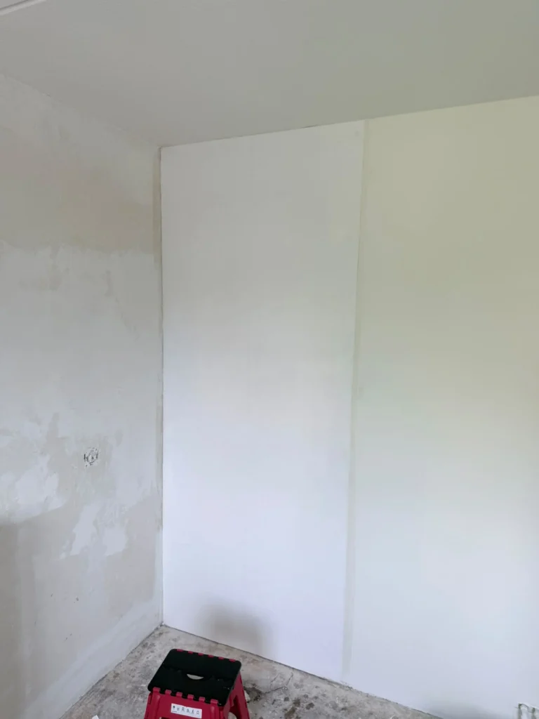 Kamerhoek met links een geplamuurde wand en rechts een wit afgewerkte wand in Castricum